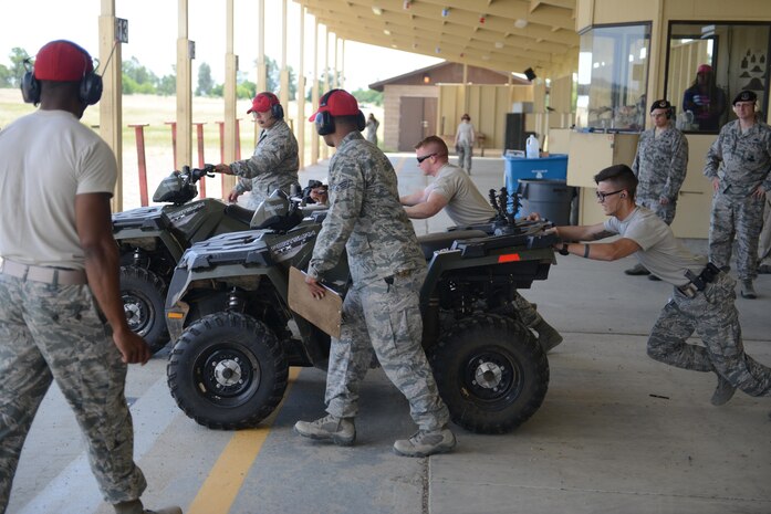 Airmen with the 9th Security Forces Squadron push ATV’s during a shooting competition May 18, 2016, at Beale Air Force Base, California. Multiple two-man teams from various military and civilian law enforcement agencies participated during the competition. (U.S. Air Force photo/ Senior Airman Bobby Cummings)