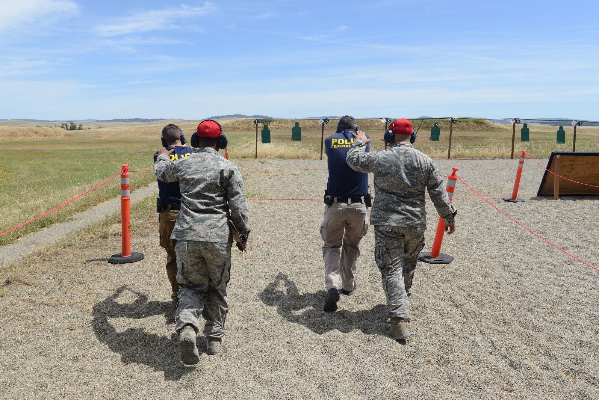 Special agents with the Air Force Office of Special Investigations fire their pistols at targets during a shooting competition May 18, 2016, at Beale Air Force Base, California. Multiple two-man teams from various military and civilian law enforcement agencies participated during the competition. (U.S. Air Force photo/ Senior Airman Bobby Cummings)