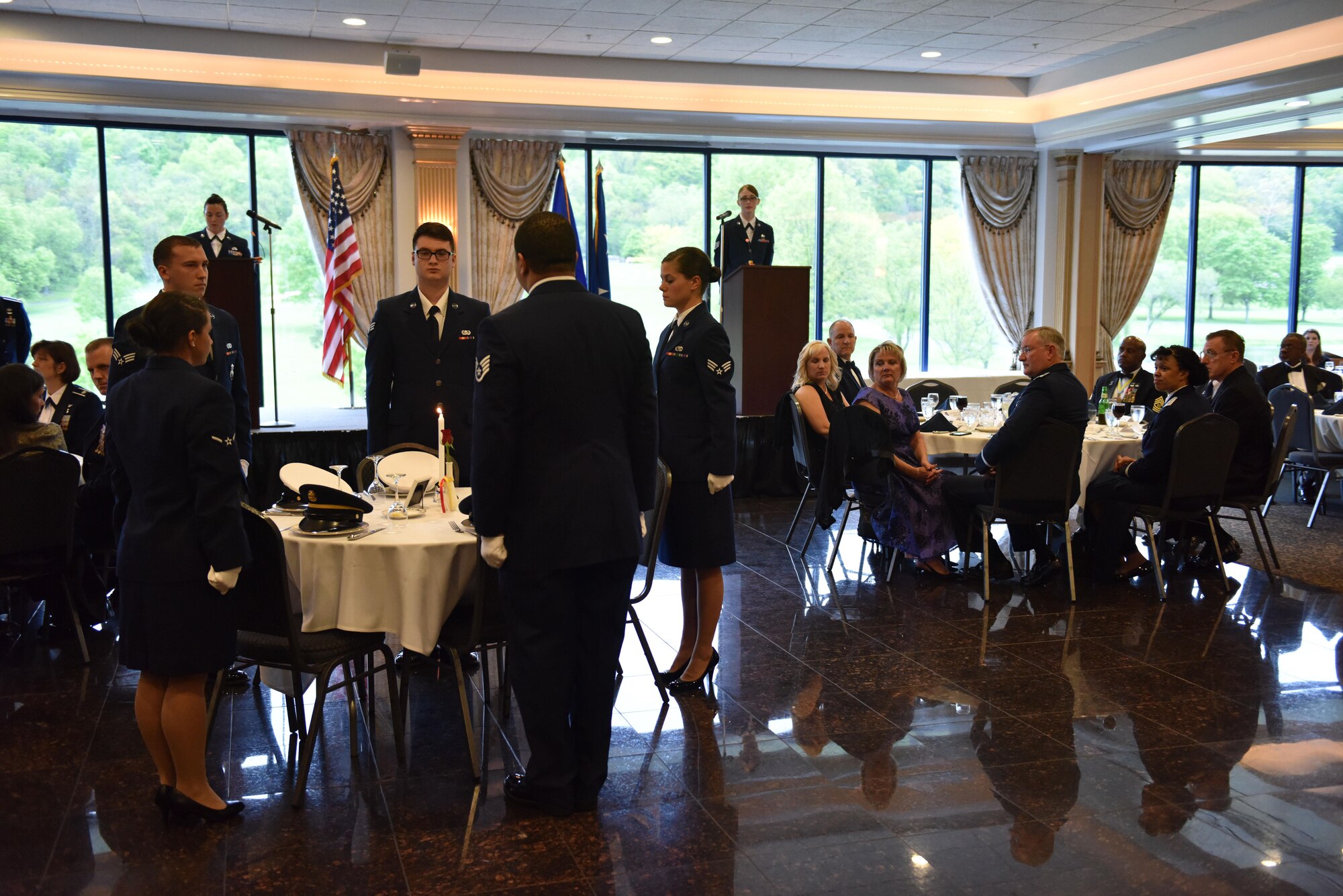 Members of the 911th Airlift Wing MIA POW team perform a ceremony to honor missing and imprisoned service members at the 911th Airlift Wing’s annual awards banquet May 14, 2016, at the Club at Shadow Lakes. Aliquippa, Pa. The ceremony revolves around an empty table set for six, symbolic of service members of all six branches of the armed forces. (U.S. Air Force photo by Airman Bethany Feenstra)