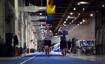 Airmen take off to run the first ever lap on the newly opened track in the Offutt Field House May 16, 2016, Offutt Air Force Base, Neb. The ergonomic, 10-foot wide track is almost a half-mile loop and is made from a synthetic rubber compound known as Protraxx and is used in National Collegiate Athletic Association sporting facilities.  (U.S. Air Force photo by Josh Plueger/Released)