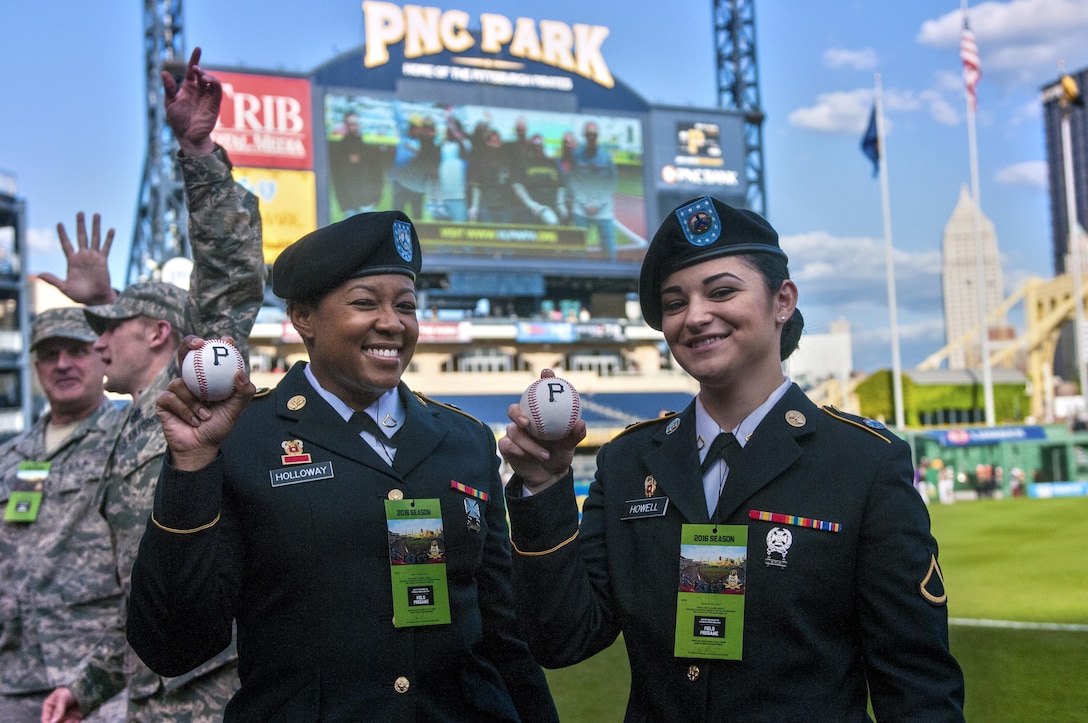 Spc. Kortney Holloway, left, and Private 1st. Class Kristyn Howell, right, both with the 316th Sustainment Command (Expeditionary), show off their commemorative baseballs before they march on the field of the Pittsburgh Pirates baseball team at PNC Park in Pittsburgh, Pa., May 19, 2016. The Pirates hosted the first Military Takes the Field night at PNC Park to honor members of all branches of the military (U.S. Army photo by Staff Sgt. Dalton Smith/Released)
