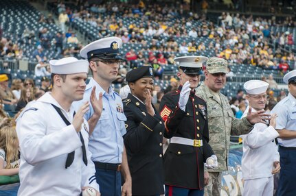 Service members from each branch of the military wave to cameramen before they march on the field of the Pittsburgh Pirates baseball team at PNC Park in Pittsburgh, Pa., May 19, 2016. The Pirates hosted the first Military Takes the Field night at PNC Park to honor members of all branches of the military (U.S. Army photo by Staff Sgt. Dalton Smith/Released)