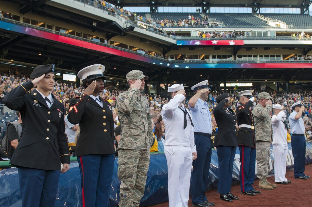 Service members from each branch of the military salute the flag during the national anthem before they march on the field of the Pittsburgh Pirates baseball team at PNC Park in Pittsburgh, Pa., May 19, 2016. The Pirates hosted the first Military Takes the Field night at PNC Park to honor members of all branches of the military (U.S. Army photo by Staff Sgt. Dalton Smith/Released)