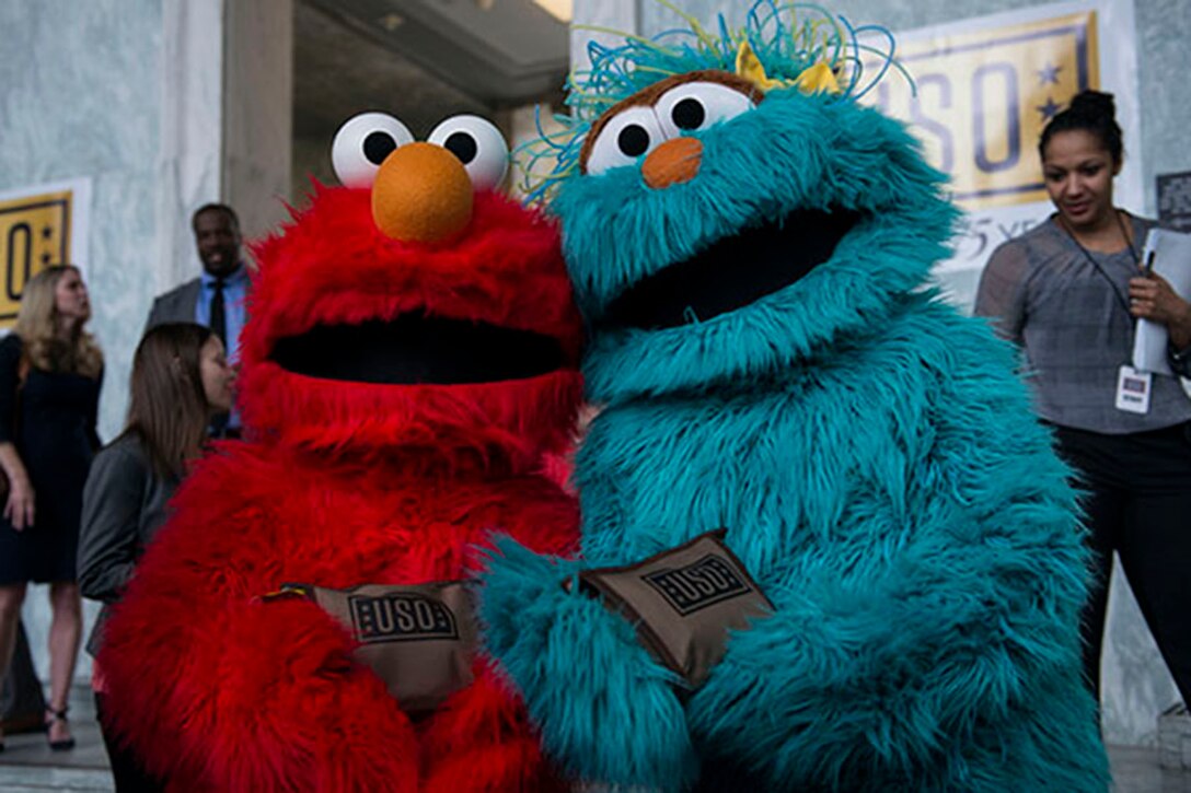 Sesame Street’s Elmo and Rosita take time out for a photo op while helping to pack USO bags for deployed service members on Capitol Hill. DoD photo by Marine Staff Sgt. Drew Tech