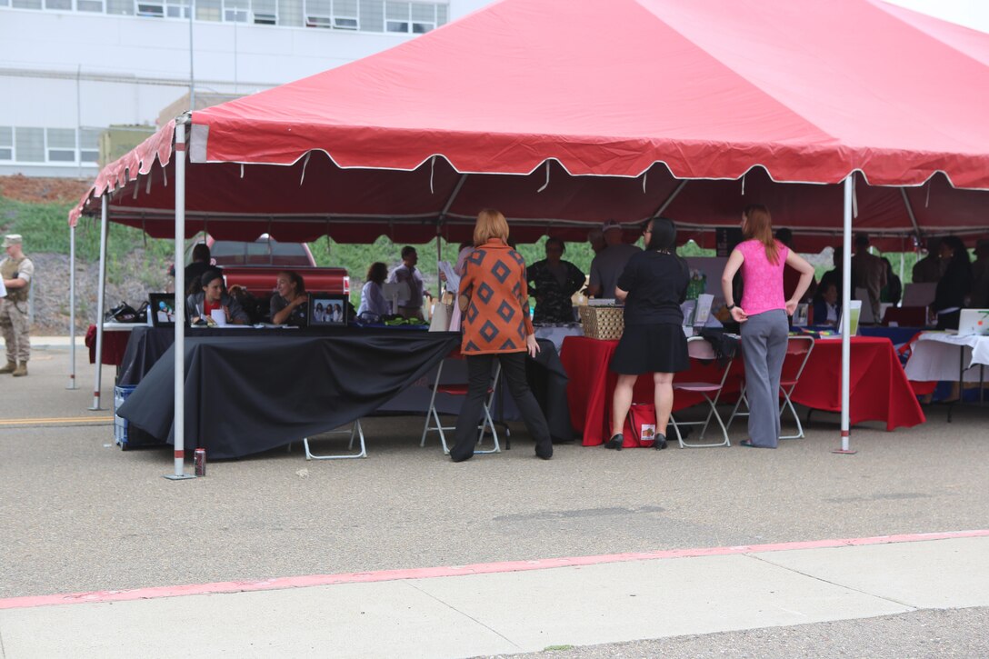 Volunteers set up booths for the Relationships, Marriage and Parenting Exposition aboard Marine Corps Air Station Miramar, Calif., May 11. The expo provided Marines, Sailors and families of 3rd Marine Aircraft Wing with resources to strengthen relationships and families. (U.S. Marine Corps photo by Pfc. Liah Kitchen/Released)