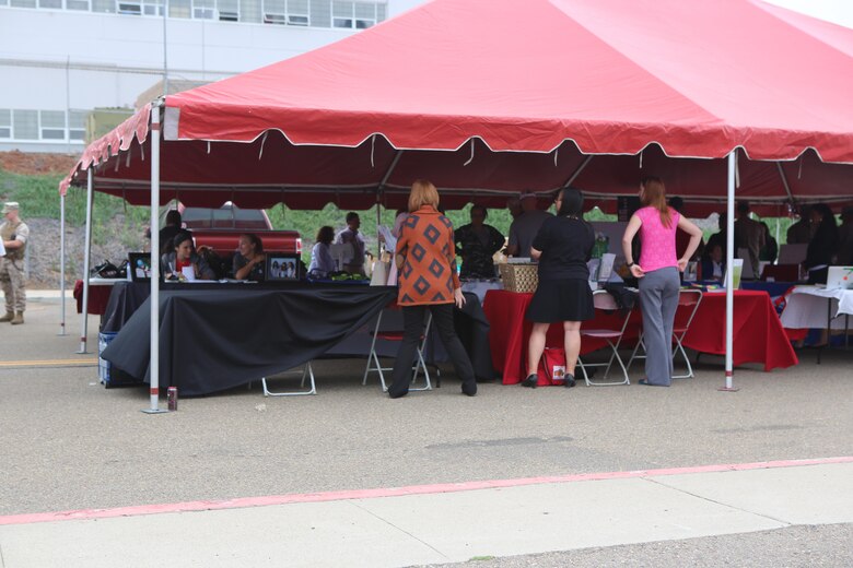 Volunteers set up booths for the Relationships, Marriage and Parenting Exposition aboard Marine Corps Air Station Miramar, Calif., May 11. The expo provided Marines, Sailors and families of 3rd Marine Aircraft Wing with resources to strengthen relationships and families. (U.S. Marine Corps photo by Pfc. Liah Kitchen/Released)