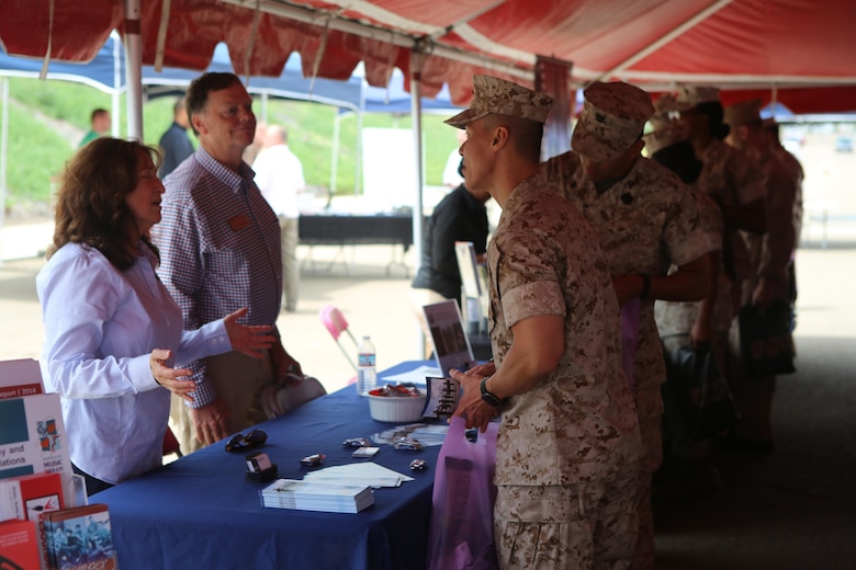 Service members get information from a booth during the Relationships, Marriage and Parenting Exposition aboard Marine Corps Air Station Miramar, Calif., May 11. The expo provided Marines, Sailors and families of 3rd Marine Aircraft Wing with resources to strengthen relationships and families. (U.S. Marine Corps photo by Pfc. Liah Kitchen/Released)