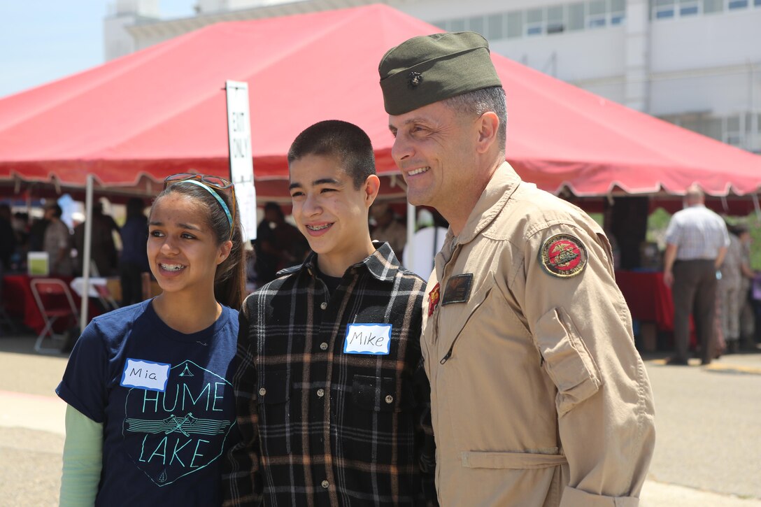 Maj. Gen. Michael Rocco, commanding general of 3rd Marine Aircraft Wing, poses for a picture during the Relationships, Marriage and Parenting Exposition aboard Marine Corps Air Station Miramar, Calif., May 11. The expo provided Marines, Sailors and families of 3rd Marine Aircraft Wing with resources to strengthen relationships and families. (U.S. Marine Corps photo by Pfc. Liah Kitchen/Released)