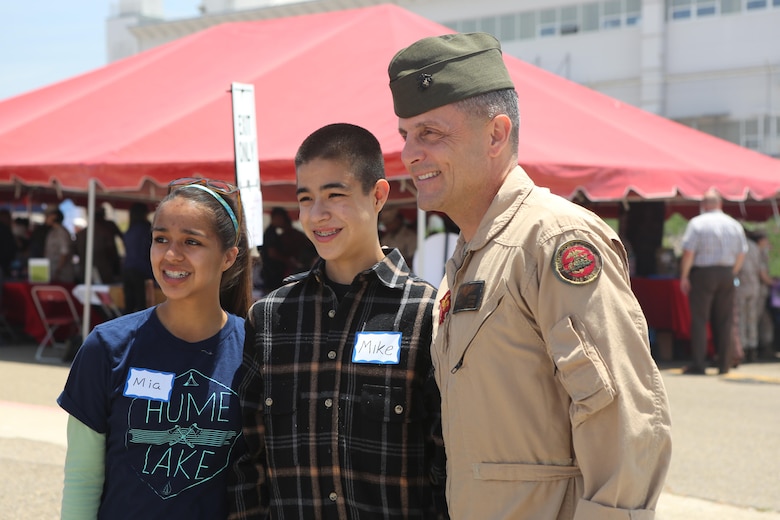 Maj. Gen. Michael Rocco, commanding general of 3rd Marine Aircraft Wing, poses for a picture during the Relationships, Marriage and Parenting Exposition aboard Marine Corps Air Station Miramar, Calif., May 11. The expo provided Marines, Sailors and families of 3rd Marine Aircraft Wing with resources to strengthen relationships and families. (U.S. Marine Corps photo by Pfc. Liah Kitchen/Released)