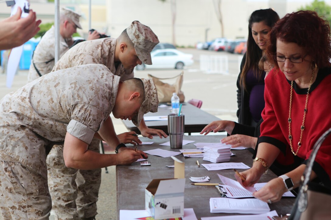 Service members register for the Relationships, Marriage and Parenting Exposition aboard Marine Corps Air Station Miramar, Calif., May 11. The expo provided Marines, Sailors and families of 3rd Marine Aircraft Wing with resources to strengthen relationships and families. (U.S. Marine Corps photo by Pfc. Liah Kitchen/Released)