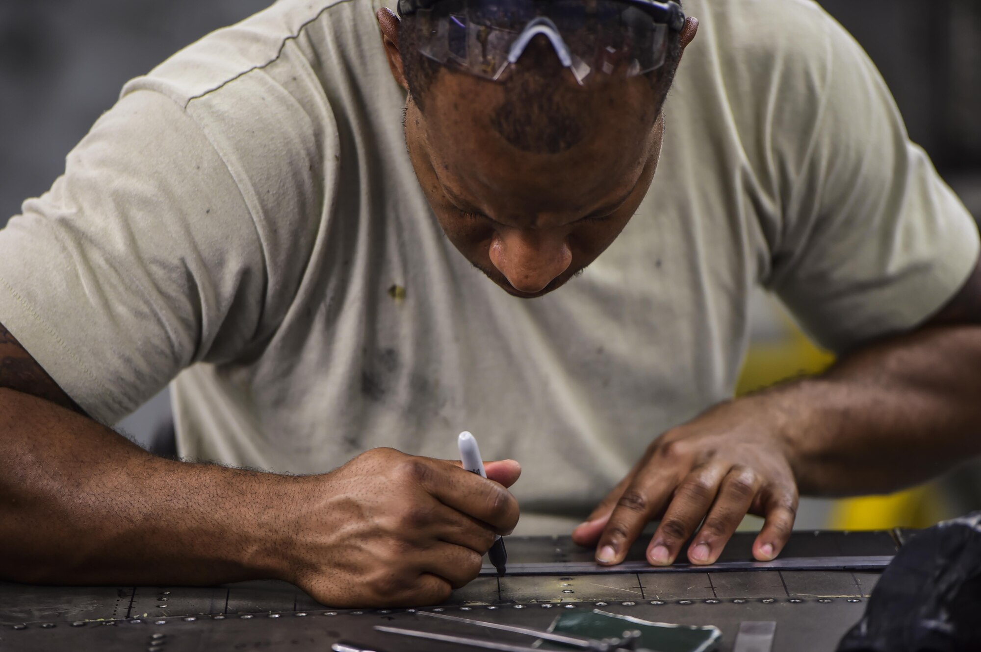 Staff Sgt. Sean Ceccil, an aircraft structural maintenance craftsman with the 1st Special Operations Maintenance Squadron, draws a mark on a C-130 wing flap at Hurlburt Field, Fla., May 17, 2016. The members that work in sheet metal use advanced equipment and techniques to reverse engineer and manufacture aircraft parts. (U.S. Air Force photo by Staff Sgt. Christopher Callaway)