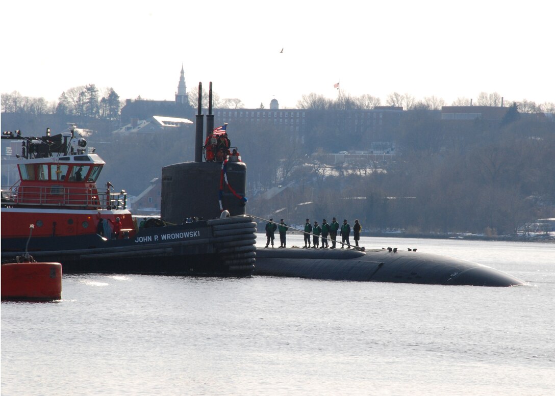 A tug boat helps guide the Los Angeles-class submarine USS Toledo through the Thames River to Naval Submarine Base New London, Conn., following a regularly scheduled deployment, Jan. 20, 2011.The USS Toledo conducted operations in U.S. Africa Command and U.S. Central Command areas of responsibility. Defense Secretary Ash Carter will visit the submarine base during his May 23-25 visit to New England. Navy photograph by Petty Officer 1st Class Virginia K. Schaefer