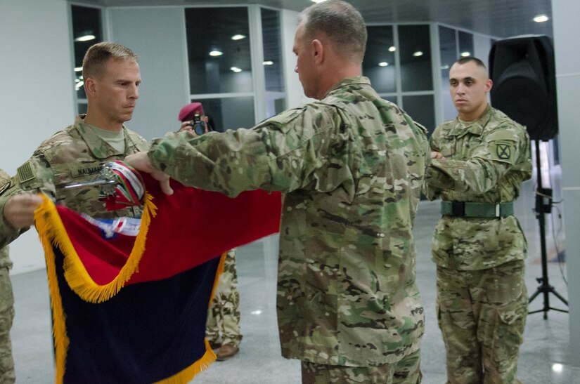 Col. Scott Naumann and Command Sgt. Maj. Timothy Rose, the command team of Task Force Warrior, furl the colors of the 1st Brigade, 10th Mountain Division “Warriors,” during a transfer of authority ceremony in Erbil, Iraq, May 17, 2016. The Warrior brigade completed a nine-month deployment in Iraq as part of Combined Joint Forces Land Component Command – Operation Inherent Resolve, building partner capacity, and advising and assisting Iraqi Security Forces.  The building partner capacity mission aims to increase the military capacity of local forces fighting the Islamic State of Iraq and the Levant.