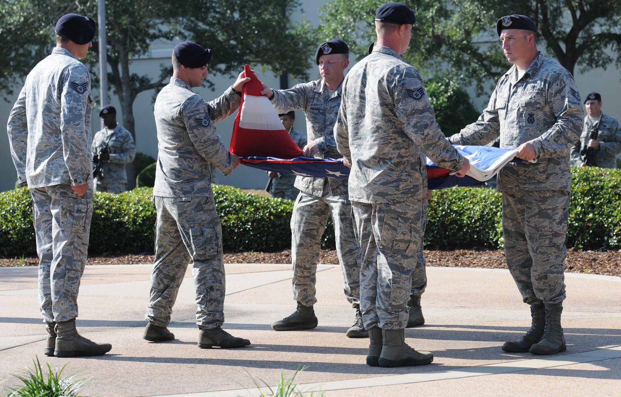 Members of the 81st Security Forces Squadron fold the U.S. flag during the 81st SFS Retreat Ceremony May 19, 2016, Keesler Air Force Base, Miss. The ceremony was held during National Police Week, which recognizes the service of law enforcement men and women who put their lives at risk every day. (U.S. Air Force photo by Kemberly Groue)