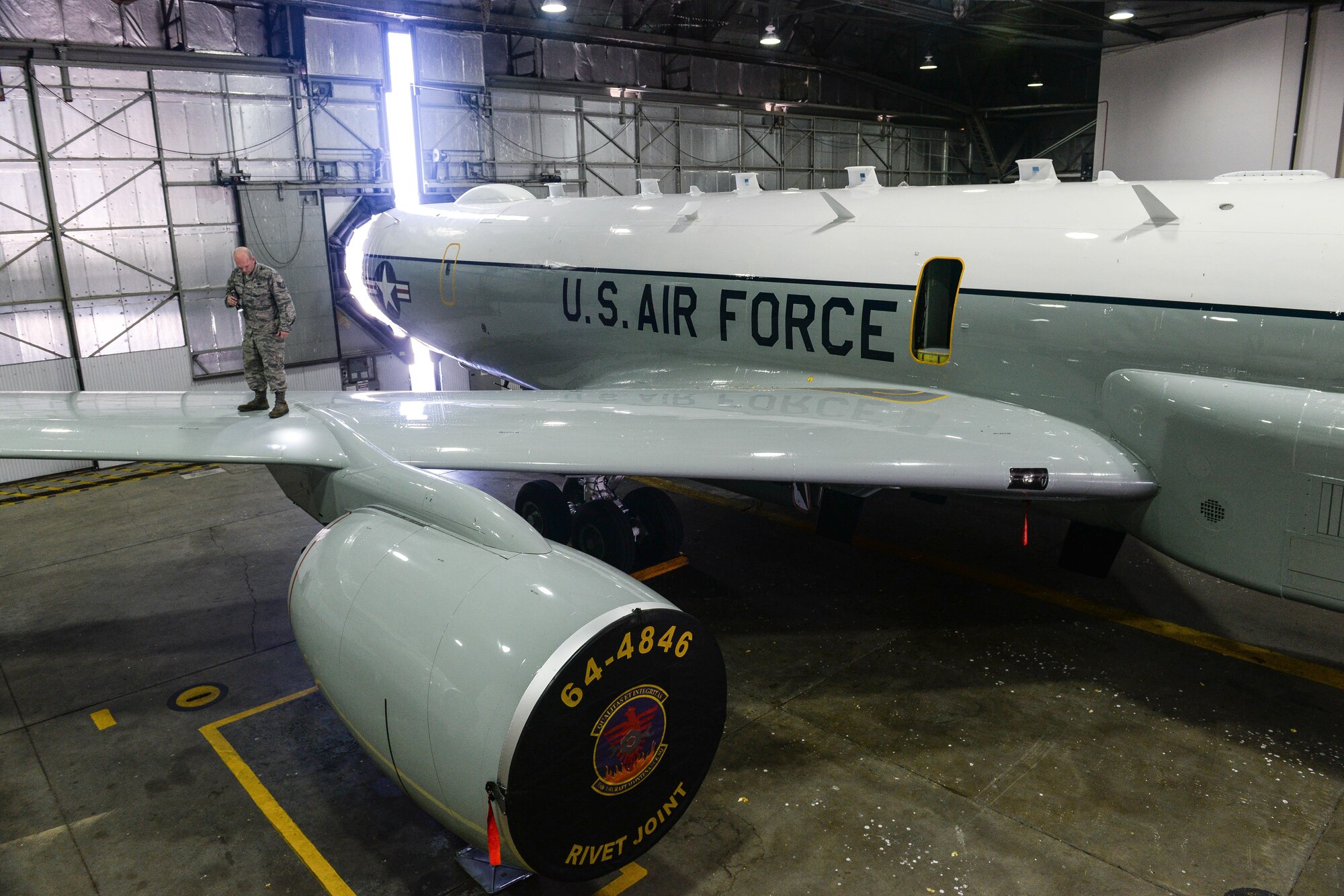 Tech. Sgt. Aaron Wilkes, 55th Aircraft Maintenance Squadron dedicated crew chief, inspects the wing of a RC-135 Rivet Joint April 24 in the Bennie Davis Maintenance Facility on Offutt Air Force Base, Nebraska. Wilkes has been at Offutt since August of 2014. (U.S. Air Force photo by Zachary Hada)  