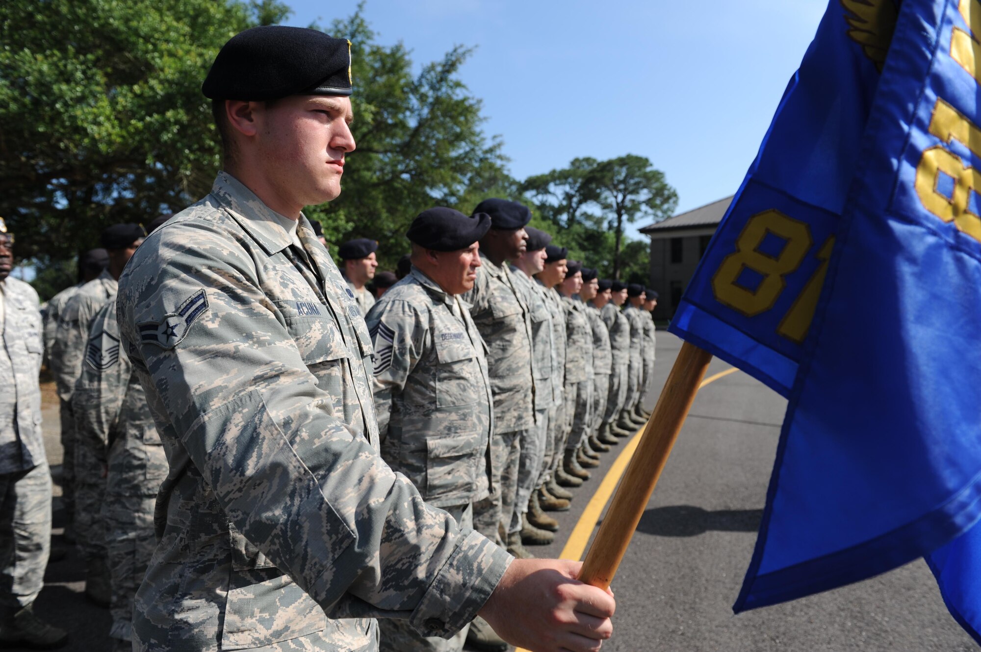 Airman 1st Class Matias Acuna, 81st Security Forces Squadron entry controller, holds the squadron guidon during the 81st SFS Retreat Ceremony May 19, 2016, Keesler Air Force Base, Miss. The ceremony was held during National Police Week, which recognizes the service of law enforcement men and women who put their lives at risk every day. (U.S. Air Force photo by Kemberly Groue)