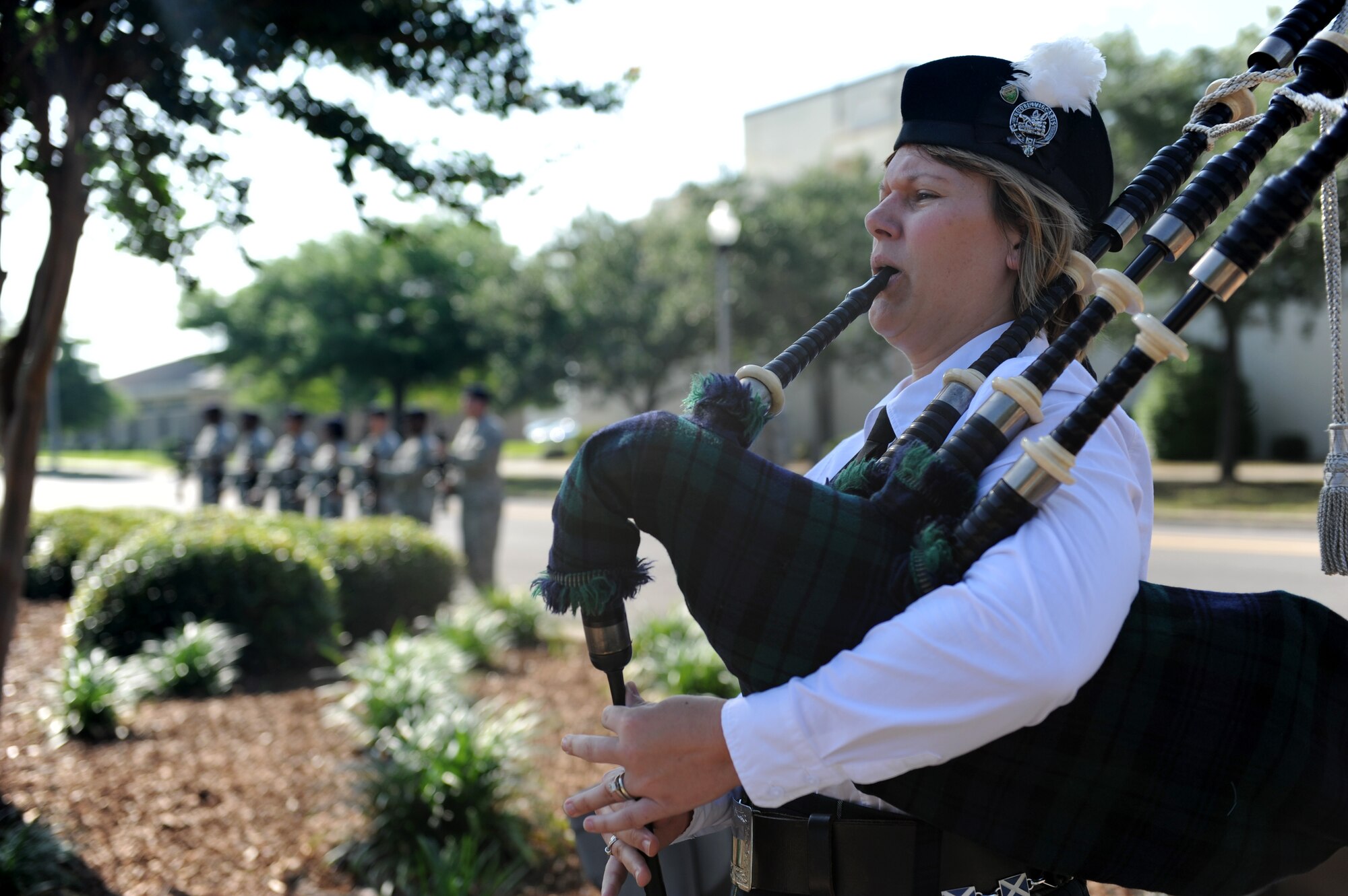 Elizabeth Doss, bagpipe player, plays taps during the 81st Security Forces Squadron Retreat Ceremony May 19, 2016, Keesler Air Force Base, Miss. The ceremony was held during National Police Week, which recognizes the service of law enforcement men and women who put their lives at risk every day. (U.S. Air Force photo by Kemberly Groue)