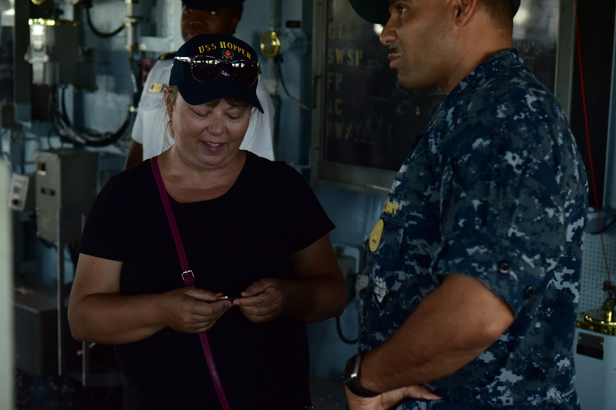 Dawn Harry, a former breast-cancer survivor from Huntington Beach, Calif., gets coined by Command Master Chief Augustine Cooper aboard the USS Hopper, May 10, 2016. Dawn’s visit to Hawaii and JBPHH is part of the Dream Foundation, which is a program that grants wishes to adults who are terminally ill. During her visit, Dawn visited the C-17 Globemaster III aircraft, The Pearl Harbor Memorial, the Silver Dolphin Bistro and the USS Hopper. (Air Force photo by Staff Sgt. Christopher Stoltz/Released)
