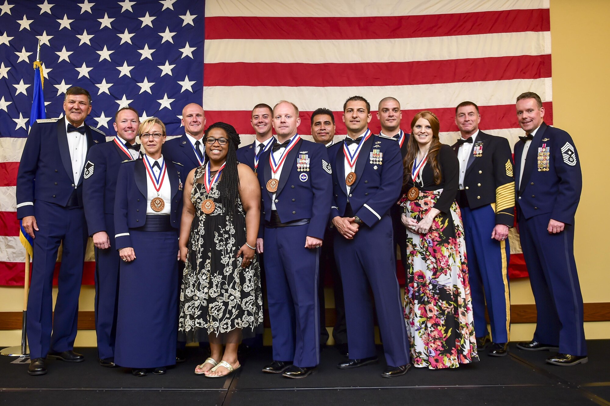 Air Force Special Operations Command Commander Lt. Gen. Brad Heithold, left, and U.S. Special Operations Command Command Sgt. Maj. William Thetford, second from right, celebrate AFSOC's 2016 outstanding Airmen and civilians of the year during a banquet at Hurlburt Field, May 19, 2016. The award winners toured Hurlburt Field May 17 and 18  before being honored at the yearly awards banquet held May 19 to celebrate their accomplishments. (U.S. Air Force photo by Senior Airman Jeff Parkinson)