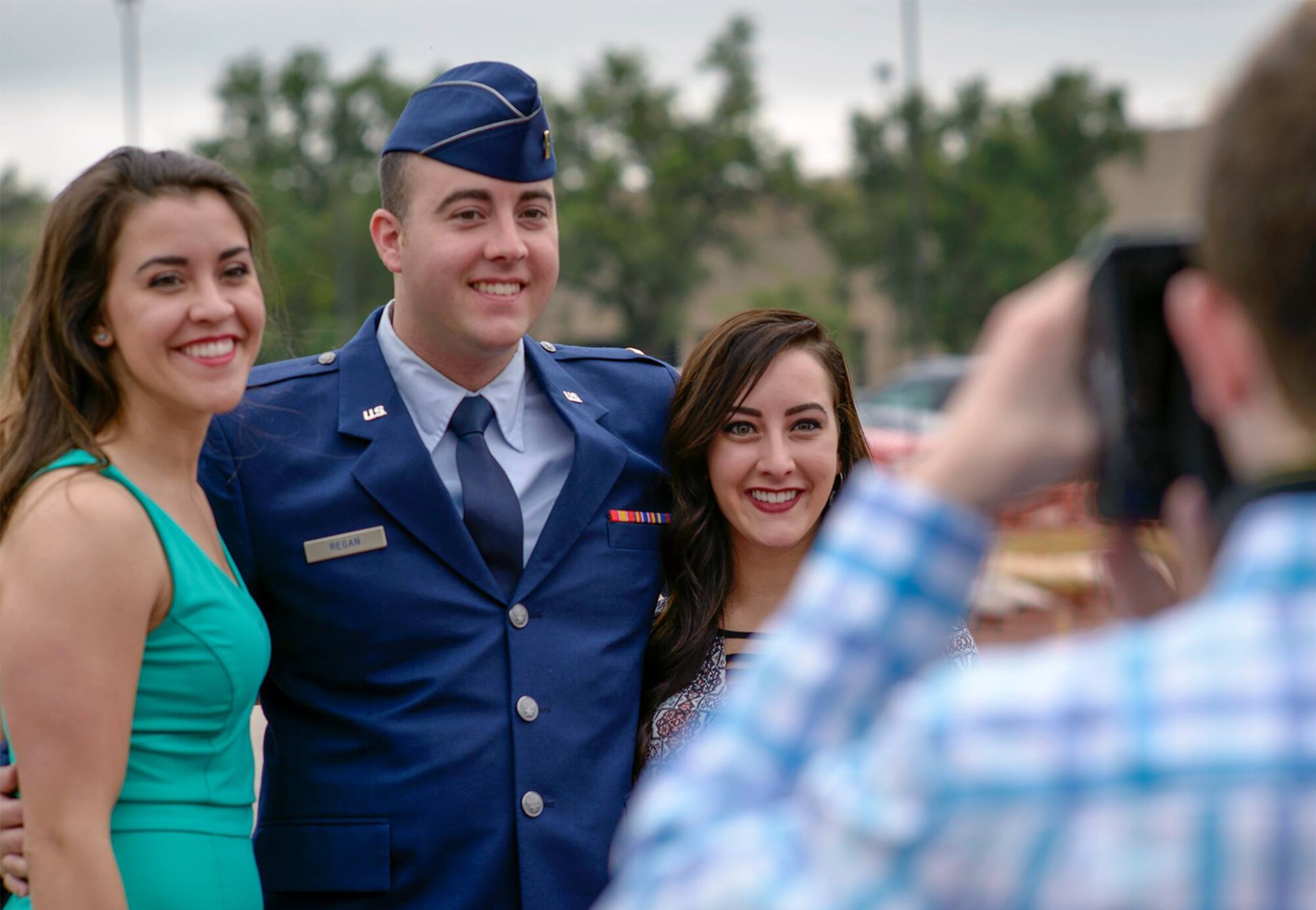 From left, Grace Regan, 2nd Lt. Patrick Regan and Clare Regan pose for a photo following Specialized Undergraduate Pilot Training Class 16-09's graduation at Vance Air Force Base, Oklahoma, May 20. Lieutenant Regan was one of 15 student pilots to receive their silver wings during the ceremony. (U.S. Air Force photo by David Poe)