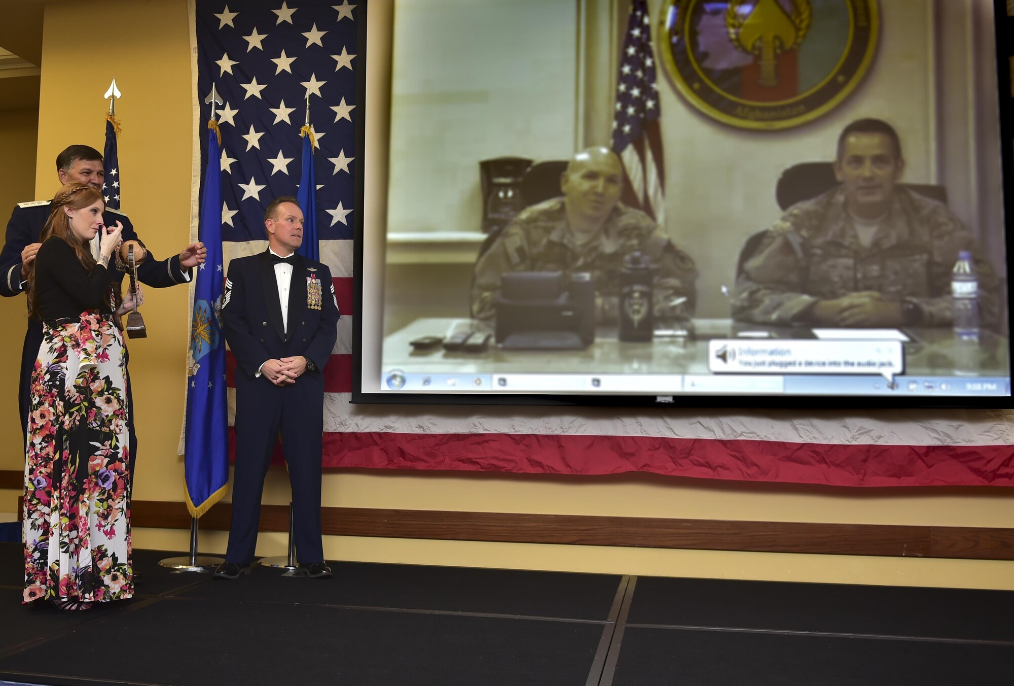 Tracy Levesque is surprised by the appearance of her deployed husband, Master Sgt. Lucas Levesque, during the Air Force Special Operations Command's outstanding Airmen and civilians of the year banquet May 19 here. Levesque -- assigned to the 901st Special Operations Aircraft Maintenance Squadron -- won first sergeant of the year honors, and he provided the emotional high-point of the night by joining the festivities via video link. (U.S. Air Force photo by Senior Airman Jeff Parkinson)