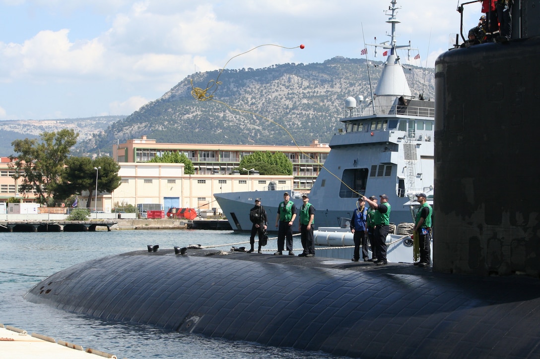 A sailor aboard the USS Springfield heaves a shot line as the submarine prepares to moor pier side during a scheduled port visit in Toulon, France, May 17, 2016. The Springfield is supporting U.S. national security interests in Europe.  Navy photo