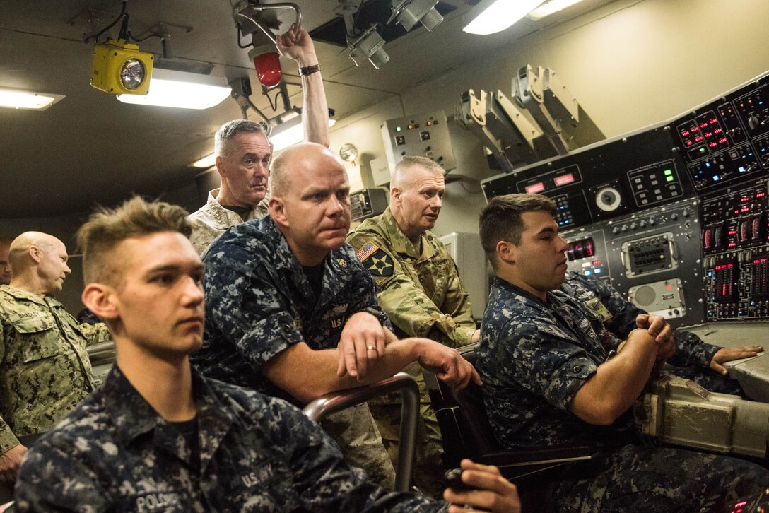 Marine Corps Gen. Joe Dunford, chairman of the Joint Chiefs of Staff, and Army Command Sgt. Maj. John W. Troxell, second from right, the chairman's senior enlisted advisor, receive a submarine training demonstration from students at the Trident Training Facility at Naval Submarine Base Kings Bay, Ga., May 20, 2016. DoD photo by D. Myles Cullen