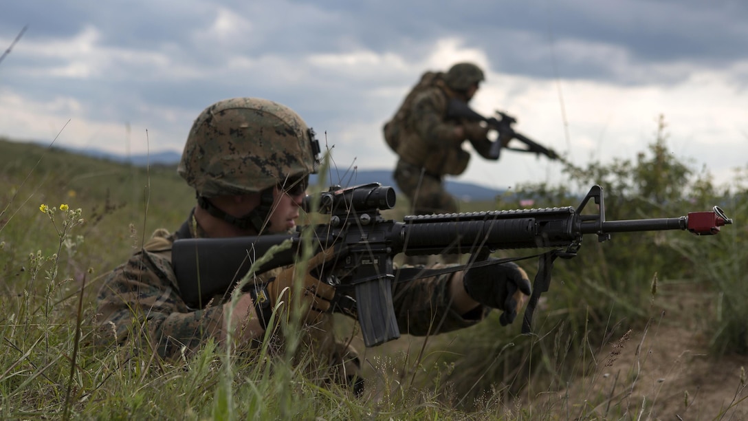 Cpl. Jacob Granado, military police, with 4th Law Enforcement Battalion, Force Headquarters Group, Marine Forces Reserve, prepares to rush forward to engage a simulated enemy during exercise Platinum Wolf 2016 at Peacekeeping Operations Training Center South Base, Bujanovac, Serbia, May 19, 2016. The Marines are working with the partner nations of Bosnia, Bulgaria, Macedonia, Montenegro, Slovenia and Serbia during the final field exercise where they master patrols, military operation urban terrain training, and work on building their interoperability.