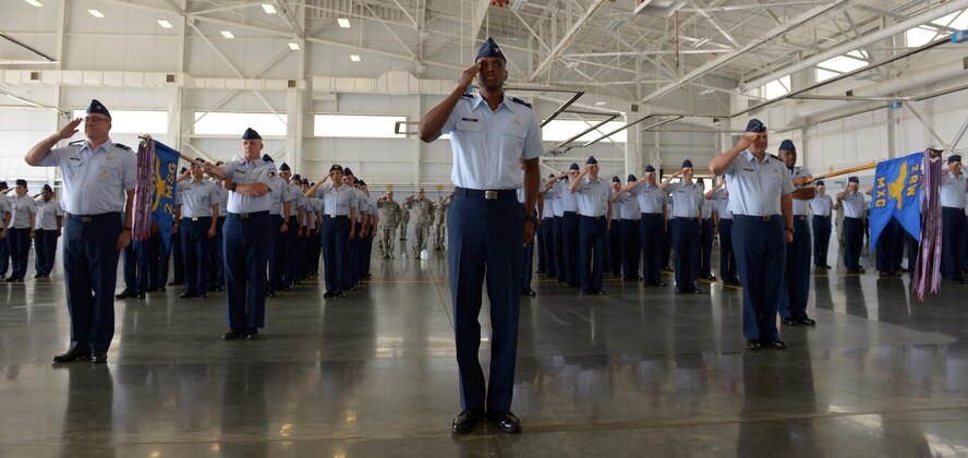 Col. Brandon Parker, 2nd Bomb Wing vice commander, leads a flight of Airmen in a salute to Col. Ty Neuman during a change of command ceremony at Barksdale Air Force Base, La., May 20, 2016. As commander, he will be charged with promoting the welfare of more than 11,400 military and civilian personnel, 6,300 family members and 25,000 retirees. (U.S. Air Force photo/Senior Airman Curt Beach)