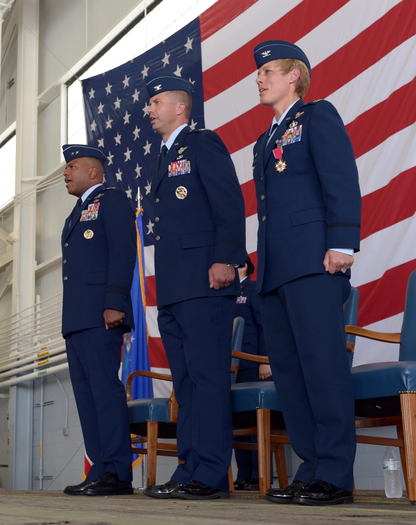 Maj. Gen. Richard Clark, 8th Air Force commander, Col. Ty Neuman, 2nd Bomb Wing incoming commander, and Col. Kristin Goodwin, 2BW outgoing commander, sing the Air Force song after a change of command ceremony at Barksdale Air Force Base, La., May 20, 2016. Neuman replaced Goodwin as commander of the 2nd BW and will be charged with promoting the welfare of more than 11,400 military and civilian personnel, 6,300 family members and 25,000 retirees. (U.S. Air Force photo/Senior Airman Curt Beach)