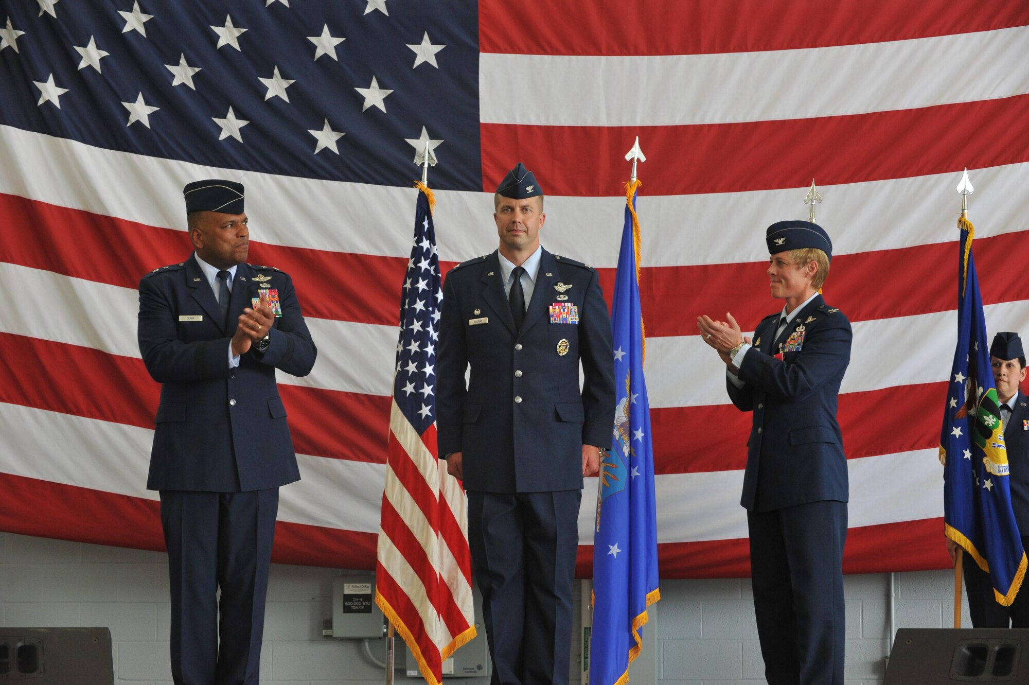Gen. Richard Clark, 8th Air Force commander, and Col. Kristin Goodwin, 2nd Bomb Wing outgoing commander, applaud after Col. Ty Neuman assumed command of the 2nd BW during the 2nd BW change of command Ceremony at Barksdale Air Force Base, La., May 20, 2016. As commander, he will support 32 tenant units, including headquarters Air Force Global Strike Command, headquarters 8th Air Force and Air Force Reserve Command's 307th Bomb Wing. (U.S. Air Force photo/Senior Airman Joseph Raatz)