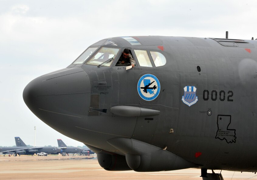 A 2nd Bomb Wing Airman unveils Col. Ty Neuman’s name from the 2nd BW's flagship B-52 Stratofortress after a change of command ceremony at Barksdale Air Force Base, La., May 20, 2016. B-52 tail number 60-0002, known as the “Spirit of Bossier and Shreveport,” displays the name of the current commander of the 2nd Bomb Wing throughout their tenure. (U.S. Air Force photo/Senior Airman Joseph Raatz)