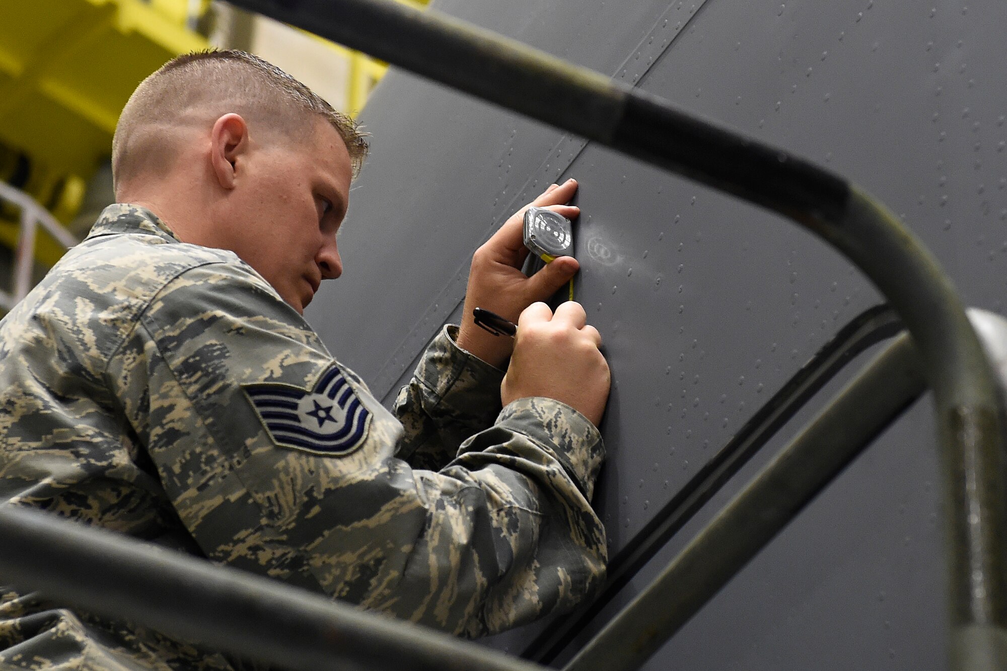 Tech. Sgt. Toby Abernathy, 62nd Maintenance Squadron corrosion control manager, applies a stencil to a 62nd Airlift Wing C-17 Globemaster III for the naming of the aircraft May 12, 2016 at Joint Base Lewis-McChord, Wash. The name, “The Spirit of the Hump” comes from the airlift missions, known as flying the hump, that were flown over the Himalayan Mountains between India and China from 1943 to 1945 involving U.S. C-46 Commandos and C-47 Skytrains. (U.S. Air Force photo/Tech. Sgt. Tim Chacon) 