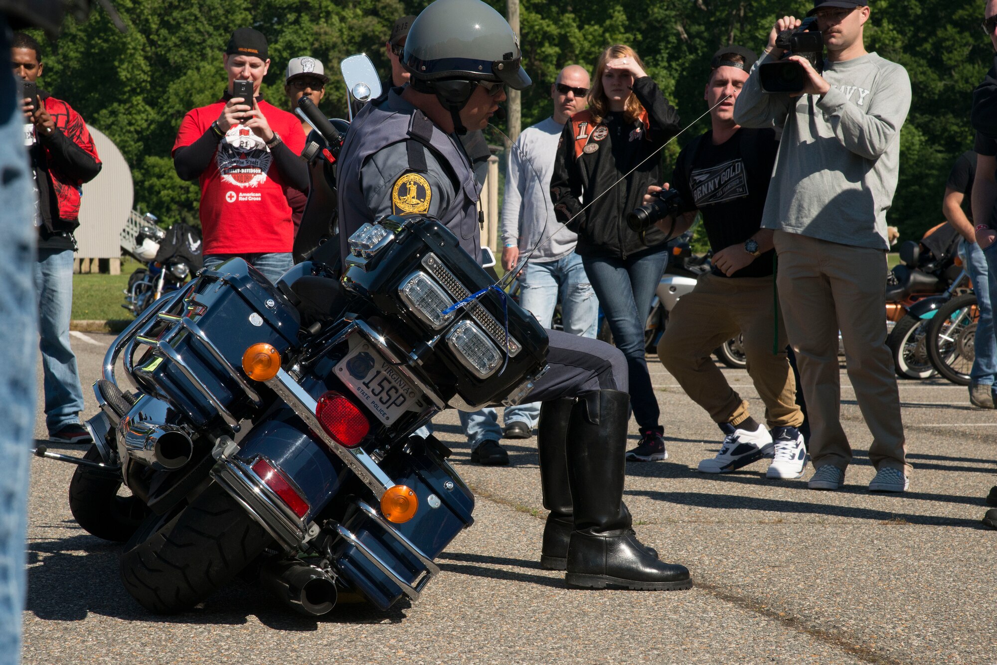 Officer Vance, with the Virginia State Police, shows riders how to properly and safely roll their motorcycle if they tip over while riding at Fort Eustis, Va., May 20, 2016. The state police conducted safety checks and demonstrated the maneuverability of the police motorcycles during the event. (U.S. Air Force photo by Senior Airman Kristina LaCoste)