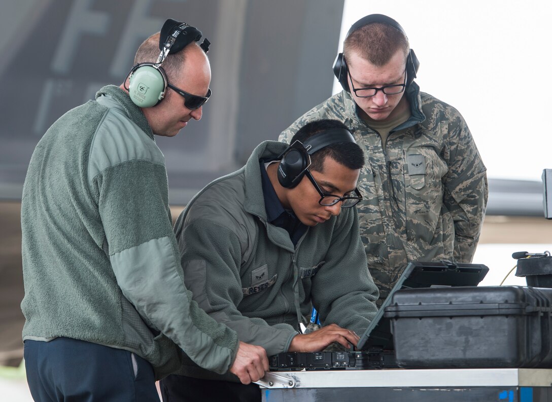 U.S. Airmen assigned to the 94th Aircraft Maintenance Unit check computer data at Langley Air Force Base, Va., May 19, 2016. Airmen with the 94th AMU launched 12 F-22 Raptors from Langley to Joint Base Elmendorf-Richardson, Alaska as they are set to participate in Red Flag-Alaska 16-2 and Distant Frontier. (U.S. Air Force photo by Senior Airman Kayla Newman) 

