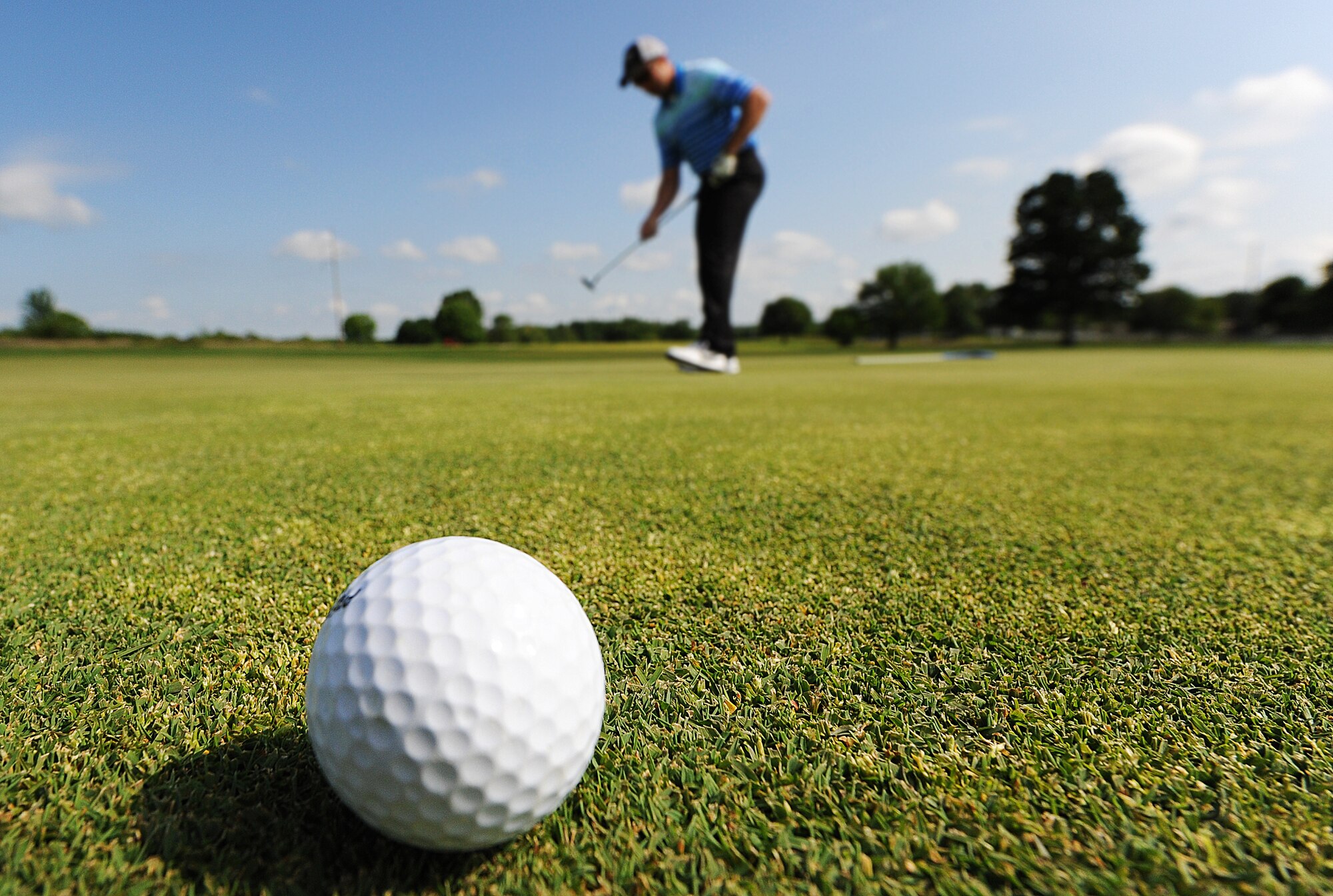 U.S. Air Force Staff Sgt. Corey Witt, a 509th Security Forces Squadron automated entry control systems manager, finishes the 16th hole at the Royal Oaks Golf Course in Knob Noster, Mo., May 18, 2016. Members of Team Whiteman participated in the golf outing along with softball, bowling and other games as part of a tournament recognizing National Police Week. (U.S. Air Force photo by Airman 1st Class Michaela R. Slanchik)