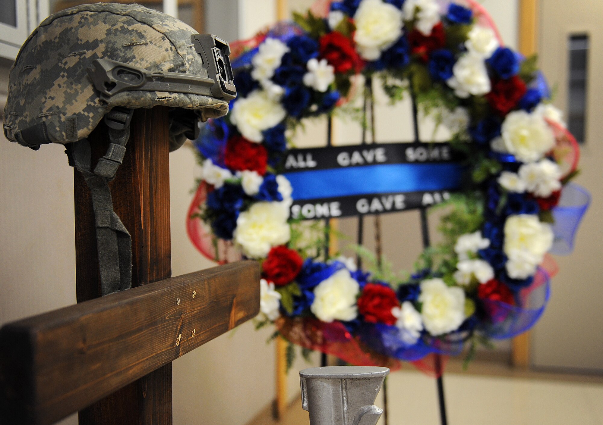 A battlefield cross is displayed in the 509th Security Forces Squadron building for National Police Week at Whiteman Air Force Base, Mo., May 16, 2016. Whiteman honored National Police Week, May 16-20, with events such as a vigil for fallen law-enforcement officers, a memorial 5K run and a base-wide tournament including golf, bowling, softball and other games. (U.S. Air Force photo by Airman 1st Class Michaela R. Slanchik)
