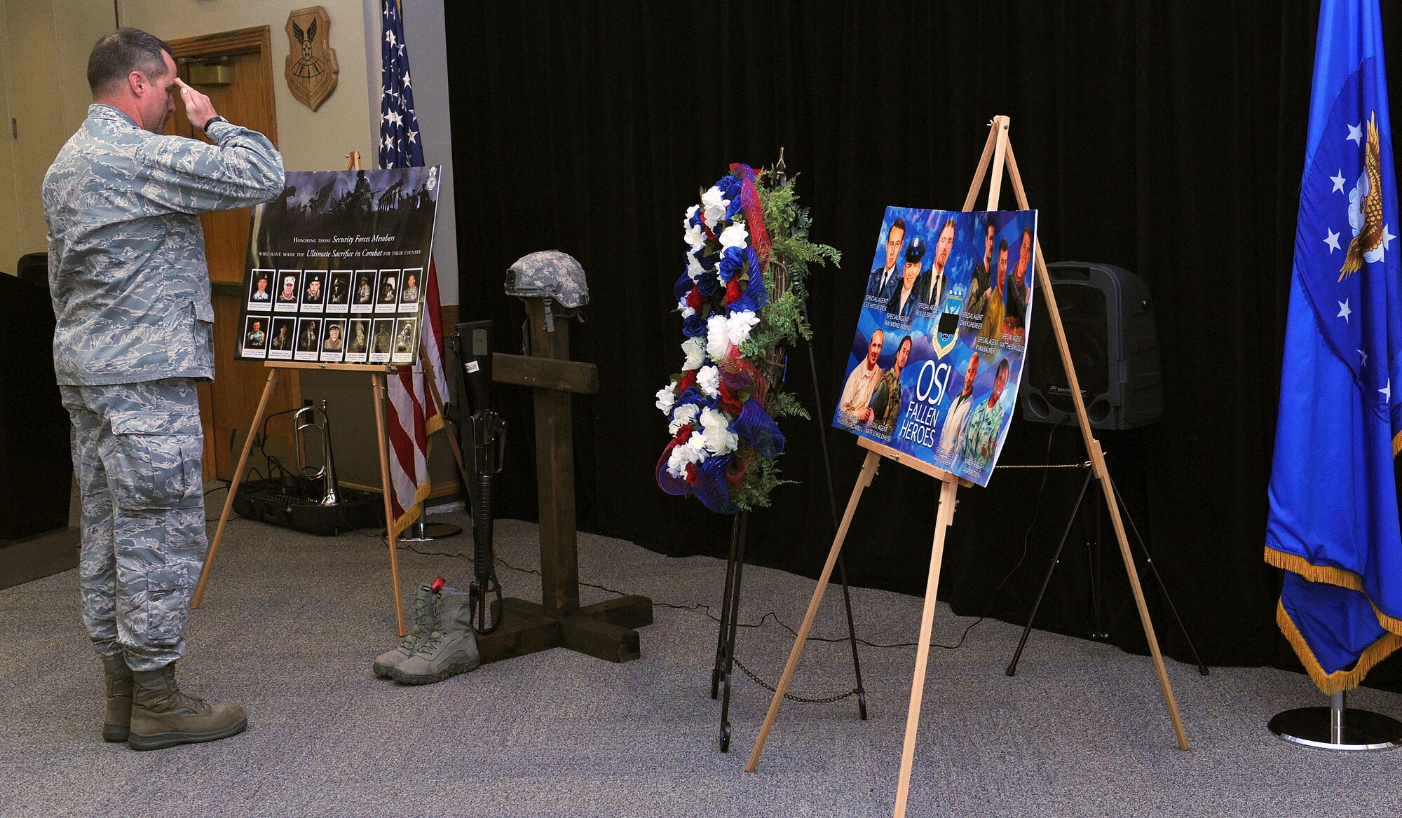 U.S. Air Force Col. Randall Sparks, the 509th Mission Support Group commander, salutes a battlefield cross after placing a rose in a boot to recognize a fallen law-enforcement member, at Whiteman Air Force Base, Mo., May 16, 2016. Every 20 minutes between reveille and retreat on the day of the vigil, volunteers recognized an officer who died in the line of duty for their sacrifice. (U.S. Air Force photo by Airman 1st Class Michaela R. Slanchik)