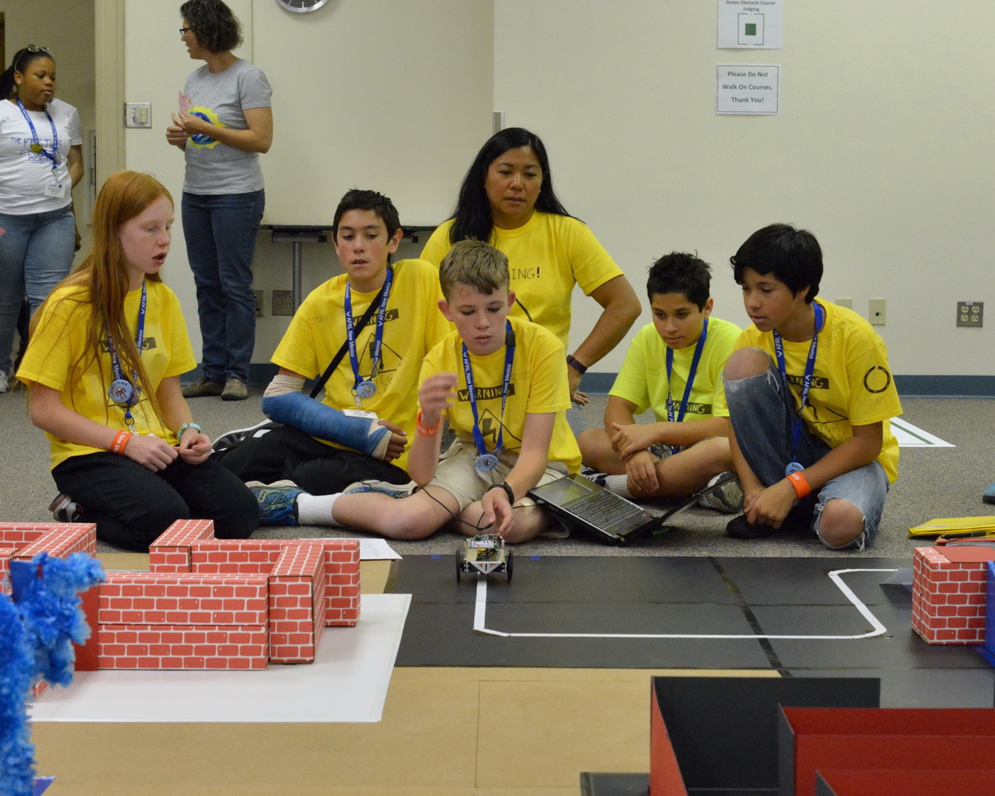 Vanessa Alter, a coach with Team High Voltage, watches her team release their robot in a 3D obstacle course, May 11, 2016, Kirtland Air Force Base, New Mexico. The robotics challenge is part of the Air Force Research Laboratory La Luz Academy. (U.S. Air Force photo by Jamie Burnett)
