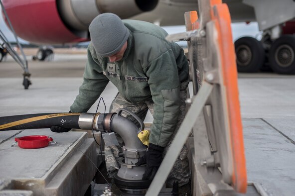 U.S. Air Force Senior Airman Joel Burger, a fuel distribution technician with the 35th Logistics Readiness Squadron, connects a Hydrant Mobile Refueler system hose to an underground fuel line at Misawa Air Base, Japan, March 22, 2016. With the HYMORE system, a hose carries fuel from the underground hydrant system directly to the aircraft, making the system more efficient. (U.S. Air Force photo by Senior Airman Brittany A. Chase)