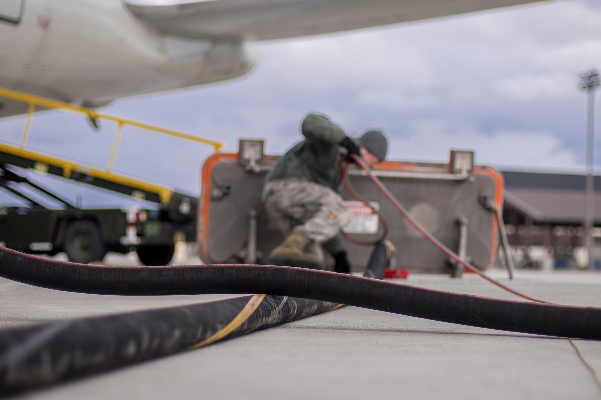 Two refueling hoses lie on the ground at Misawa Air Base, Japan, March 22, 2016. With the new HYMORE system, the refueling truck can serve as a connection point and filter to syphon fuel from the underground system, virtually supplying an unlimited amount of fuel without having to refill back at the Petroleum, Oil and Lubrication station. (U.S. Air Force photo by Senior Airman Brittany A. Chase)