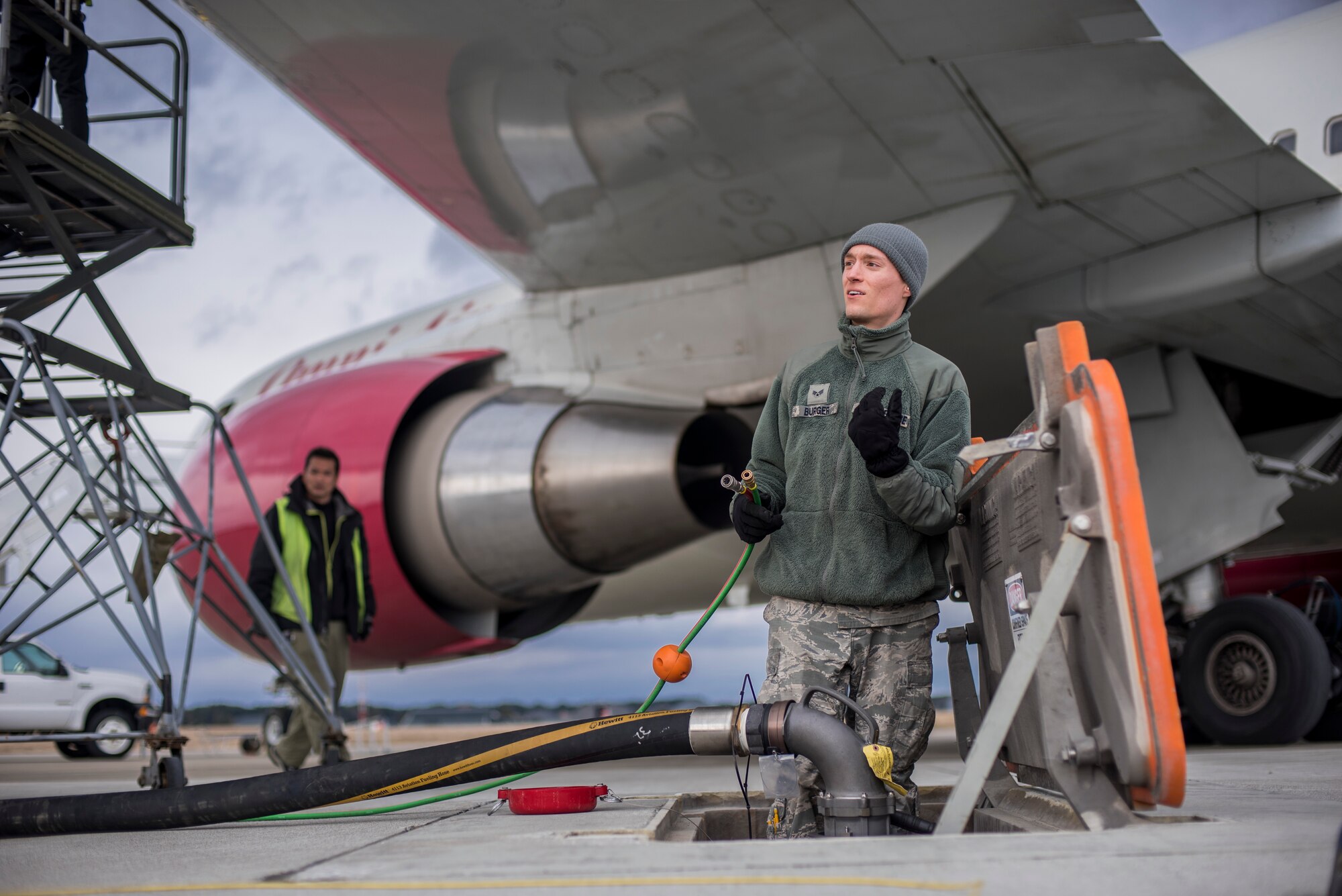 U.S. Air Force Senior Airman Joel Burger, a fuel distribution technician with the 35th Logistics Readiness Squadron, hooks up cables to monitor fuel levels at Misawa Air Base, Japan, March 22, 2016. This was the first time the new Hydrant Mobile Refueler was tested at the base. (U.S. Air Force photo by Senior Airman Brittany A. Chase)