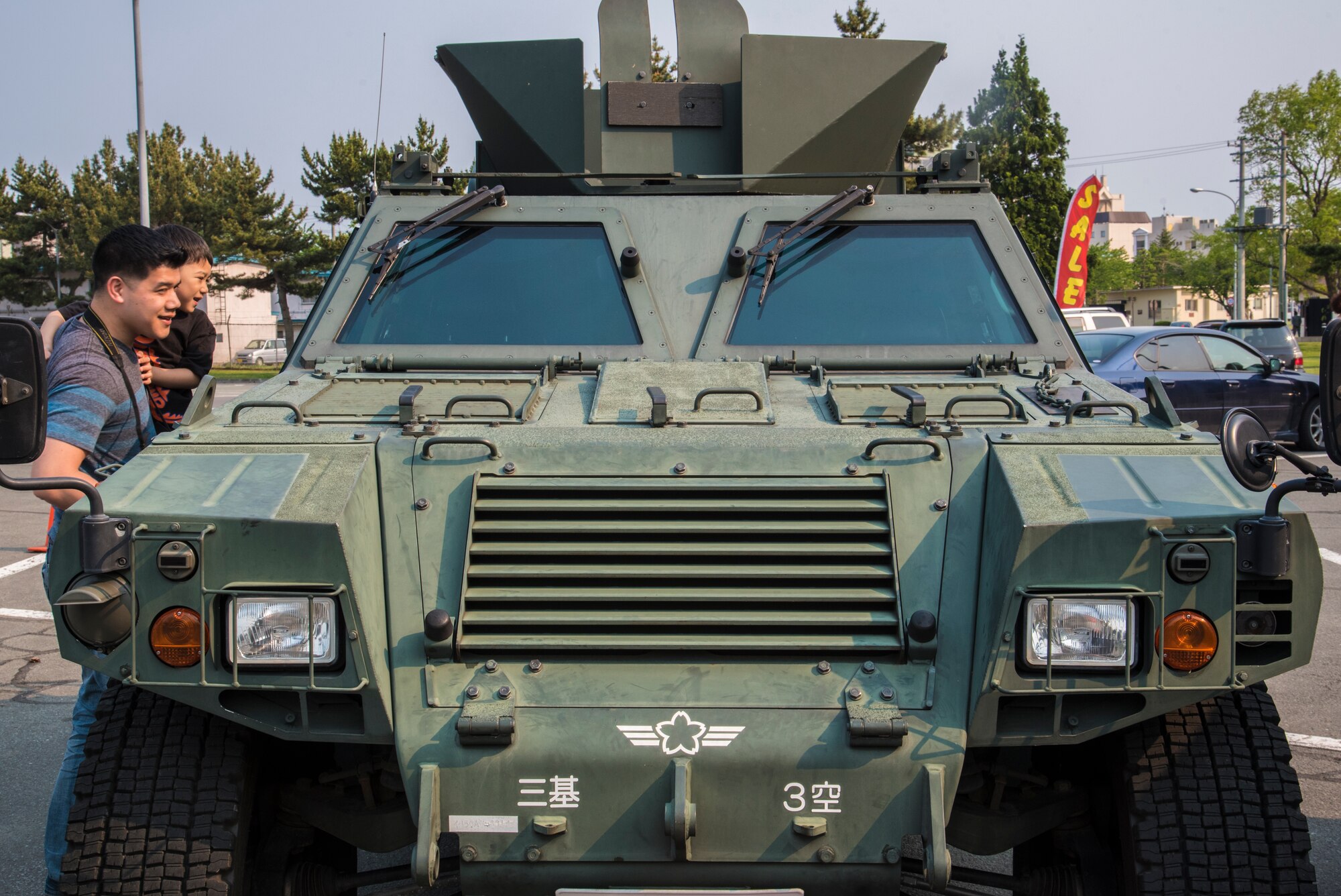 U.S. Air Force Staff Sgt. John Reilly, a senior force protector with the 35th Security Forces Squadron, and his son observe a Japanese Air Self-Defense vehicle during a static display at Misawa Air Base, Japan, May 19, 2016. The static display was an event held during Police Week, which honors police officers who died in the line of duty. (U.S. Air Force photo by Airman 1st Class Jordyn Fetter)