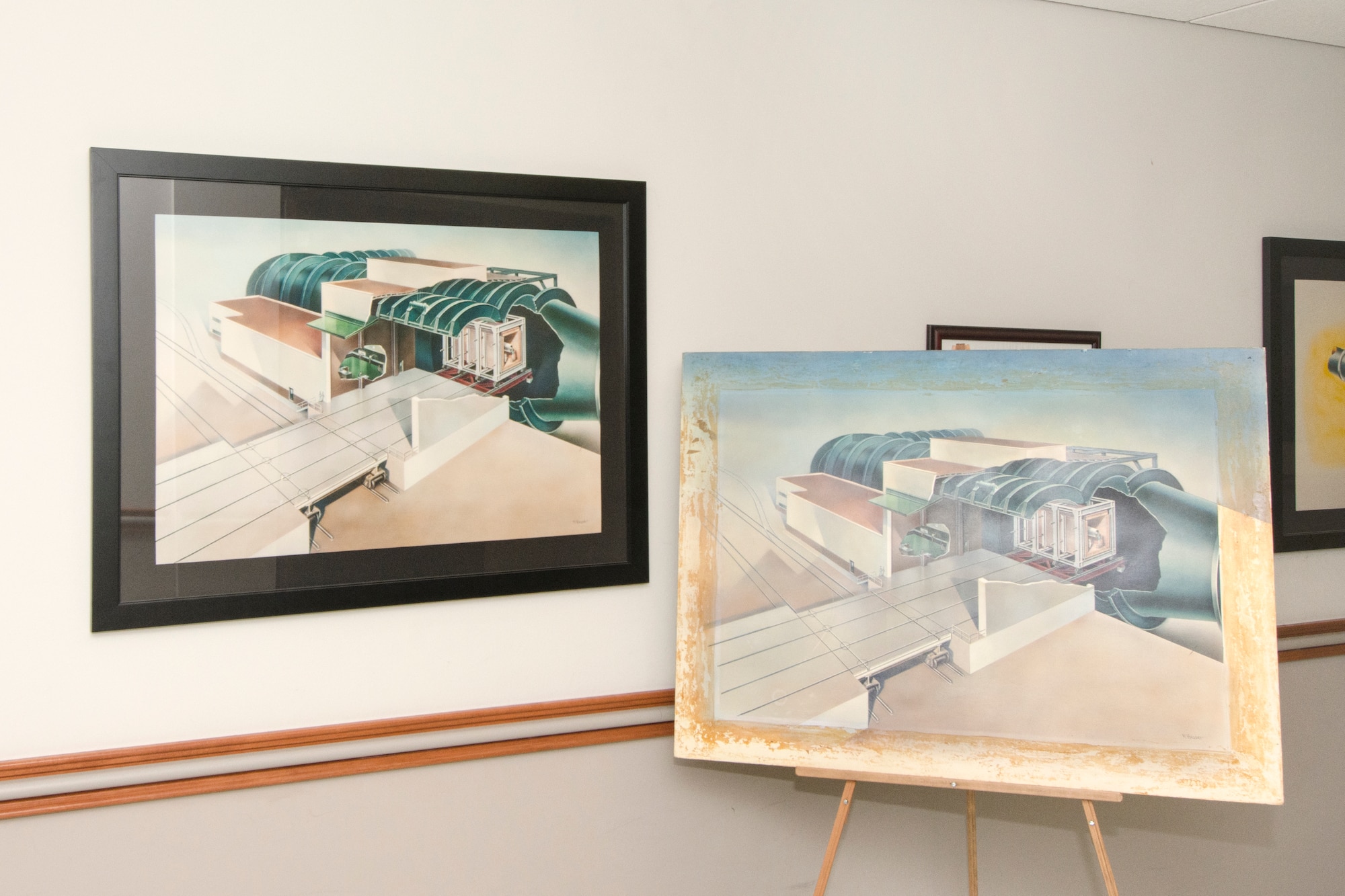 The drawing pictured here shows a before (right) and after drawing that was restored by AEDC Photographer Rick Goodfriend for display in the Administration and Engineering building which depicts AEDC history. Goodfriend and AEDC Historian Chris Rumley received the 2016 Air Force Materiel Command Excellence in Heritage Projects Award for their efforts in restoring 100 historical AEDC photographs and drawings for display in the A&E building. (U.S. Air Force photo/Jacqueline Cowan)