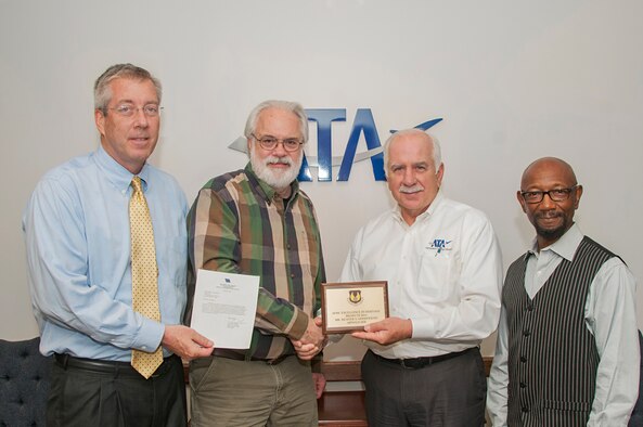 Rick Goodfriend (second from left), an AEDC photographer, receives the 2016 Air Force Materiel Command Excellence in Heritage Projects Award during a presentation gathering April 20, 2016, in the ATA General Manager’s office. Goodfriend and AEDC Historian Chris Rumley received the award for their efforts in restoring 100 historical AEDC photographs and drawings for display in the Administration and Engineering building. Pictured with Goodfriend, left to right, is ATA Deputy General Manager Jeff Haars, ATA General Manager Steve Pearson and ATA Quality and Management Systems Manager J.T. Northcutt. (U.S. Air Force photo/Jacqueline Cowan)
