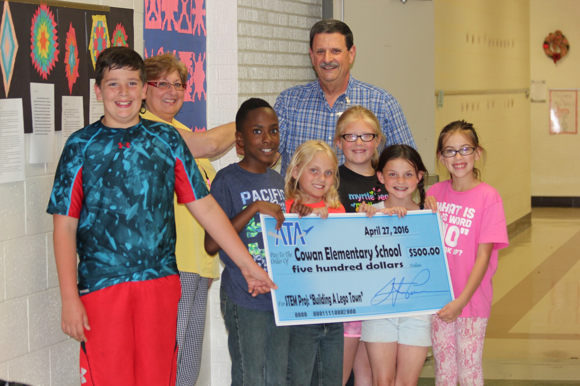 The ATA Employee and Community Activities Committee (E&CAC) recently made a donation of $500 to Cowan Elementary School. The donation will assist students in a Science, Technology, Engineering and Math projects. Pictured left to right receiving the donation are students Lane Pearson, Shaquale Brown, Bayla Acklen, Ashlynn Goff, Maddie Gore and Emily Barnes with CES teacher Debbie Skotte and E&CAC committee member Ted Boswell. (Courtesy photo)