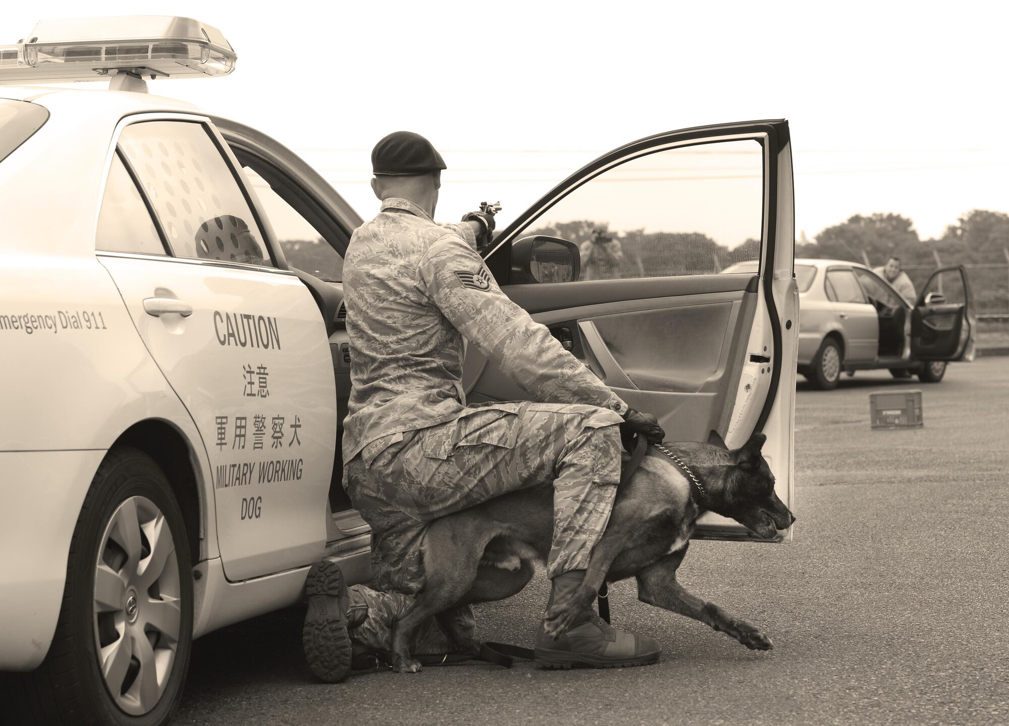 Staff Sgt. Nicholas Galbraith, 374th Security Forces Squadron military working dog handler keeps his canine, Topa, at the ready while simulating armed combat during Yokota’s Top Dog competition at Yokota Air Base, Japan, May 16, 2016. Seven canine teams competed in the event as part of Police Week, which honors Security Forces Airmen, Air Force Office of Special Investigations agents and all other law enforcement officers who have served. (U.S. Air Force photo by Airman 1st Class Elizabeth Baker/Released) 