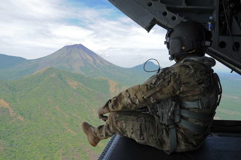 U.S. Army Sgt. King David, 1st Battalion, 228th Aviation Regiment CH-47 Chinook Crew Chief, observes the San Cristóbal volcano, one of at least six active volcanos in Nicaragua, while transporting the Joint Task Force-Bravo U.S. Southern Command Situational Assessment Team from Managua, Nicaragua and Soto Cano Air Base, Honduras, May 19, 2016. The S-SAT, which is a scalable element comprised of a team leader, civil military operations officer, air operations planer, engineer operations planner, logistics planner, communications planner, medical planner and force protection planner, who provide critical information to governmental and non-governmental disaster response teams so they know what to expect and plan for when they arrive. The JTF-Bravo S-SAT was invited to Nicaragua to demonstrate their ability to respond to a disaster situation and integrate with the U.S. Embassy, Managua, Community Emergency Response Team and the Nicaraguan National System for Prevention and Attention to Disasters (SINAPRED) to aid in the response and alleviate human suffering. (U.S. Air Force Photo by Capt. David Liapis)