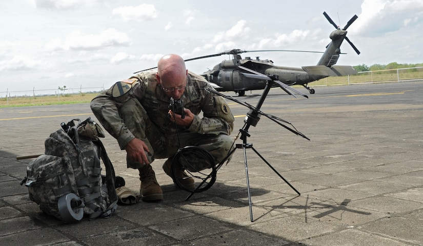 U.S. Army Staff Sgt. Jayson Toohey, U.S. Southern Command Situational Assessment Team communications specialist, establishes contact with the Joint Task Force-Bravo operations center at Soto Cano Air Base, Honduras from the flight line of Augusto C. Sandino International Airport in Managua, Nicaragua, May 16, 2016. Toohey was part of a nine-person S-SAT that was invited to demonstrate their disaster response assistance capabilities to the Nicaraguan Civil Defense and U.S. Embassy, Managua, Community Emergency Response Team. (U.S. Air Force Photo by Capt. David Liapis)