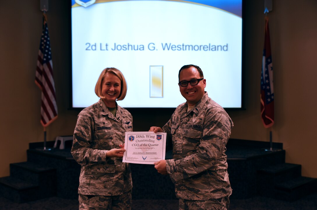 1st Lt. Joshua Westmoreland, intelligence flight commander, accepts the Outstanding Airman of the Quarter award from Col. Bobbi Doorenbos, 188th Wing commander, May 15, 2016, during a commander’s call at Ebbing Air National Guard Base, Fort Smith, Ark. The Outstanding Airman of the Quarter award is given to Airmen that have provided exceptional service to the wing throughout the last quarter and distinguished themselves among the best in the 188th. Winners were selected in the Airman, Noncommissioned Officer, Senior NCO, Company Grade Officer and Field Grade Officer categories. (U.S. Air National Guard photo by Senior Airman Cody Martin/Released)